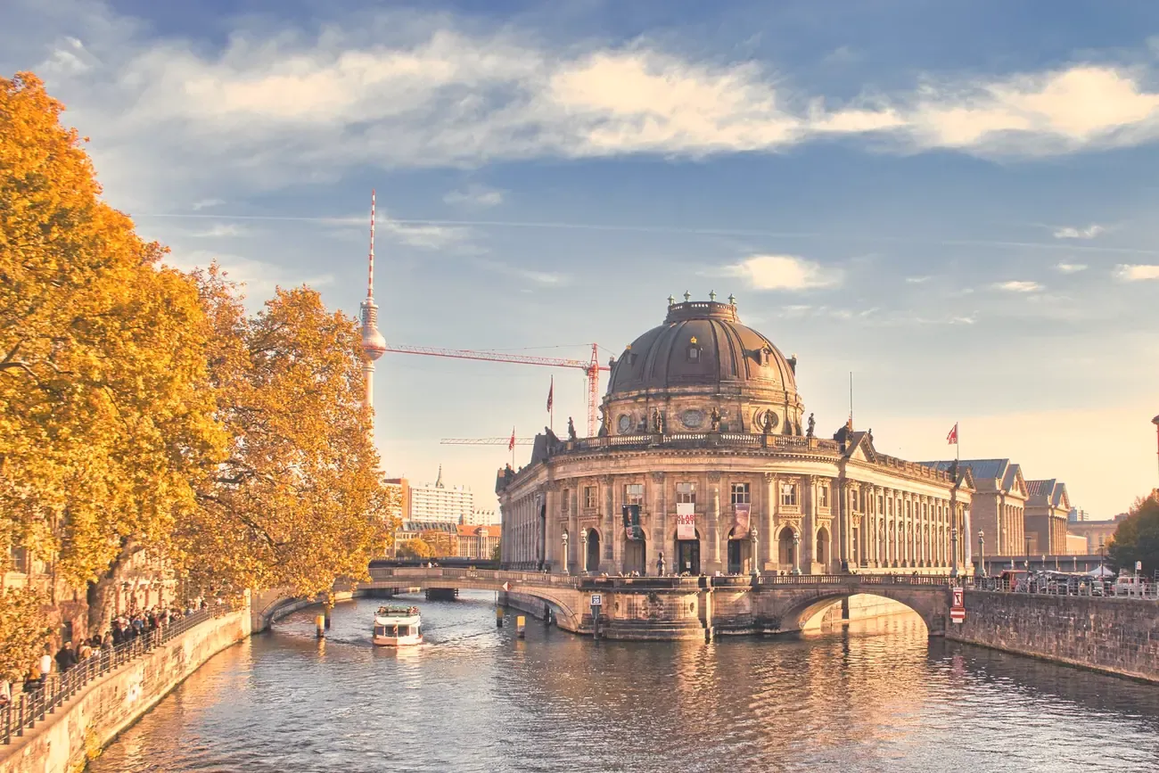 The Bode Museum in Berlin in autumn, with the TV Tower visible along the Spree river