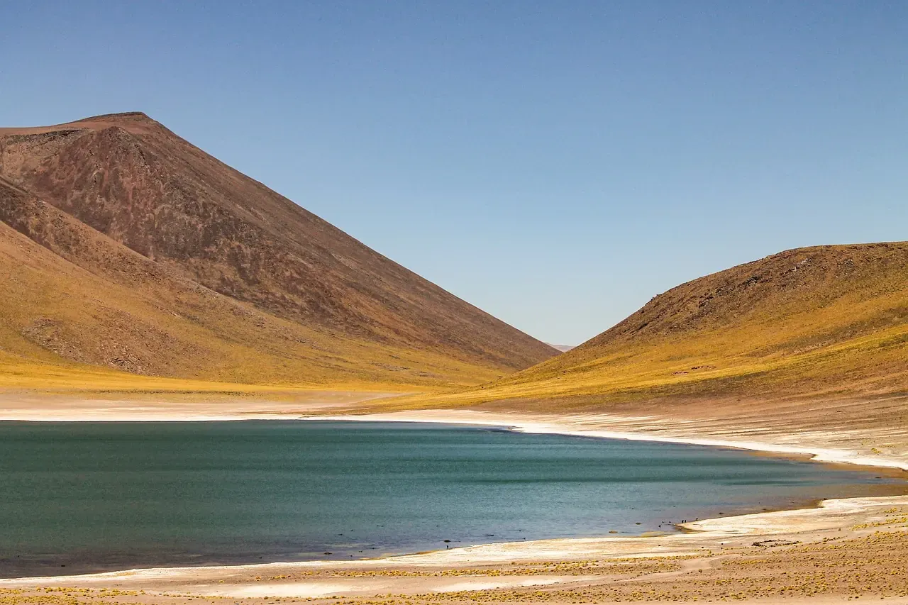 A high-altitude lagoon between bare hills on the Atacama altiplano, Chile