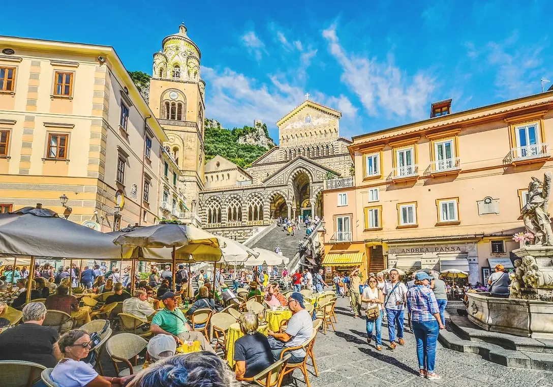 Cafes in the Piazza Duomo in Amalfi, Italy, with the cathedral in the background