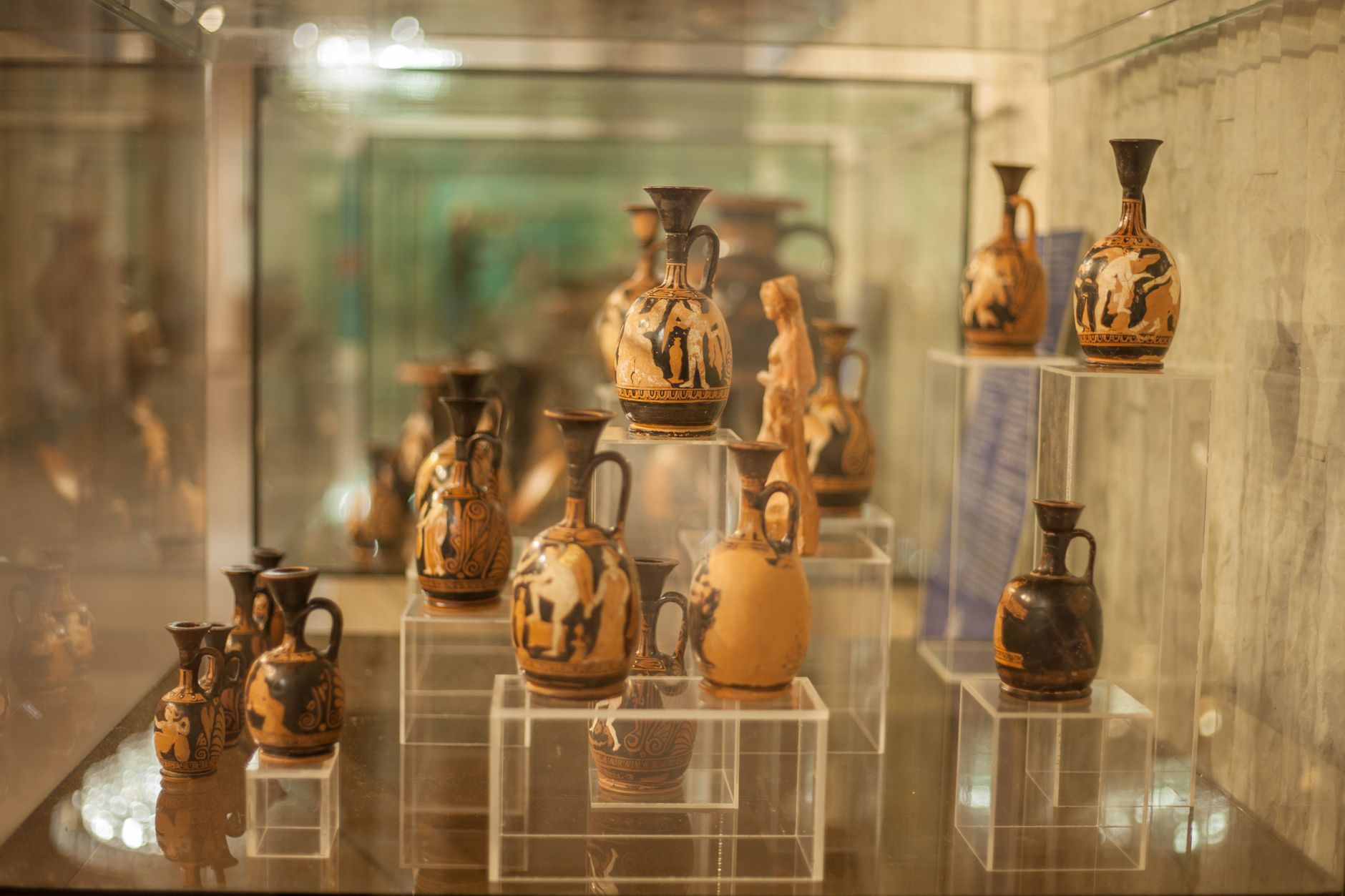 Ancient Greek pottery vessels displayed in a museum setting, representative of the Magna Graecia pottery held by the museum.