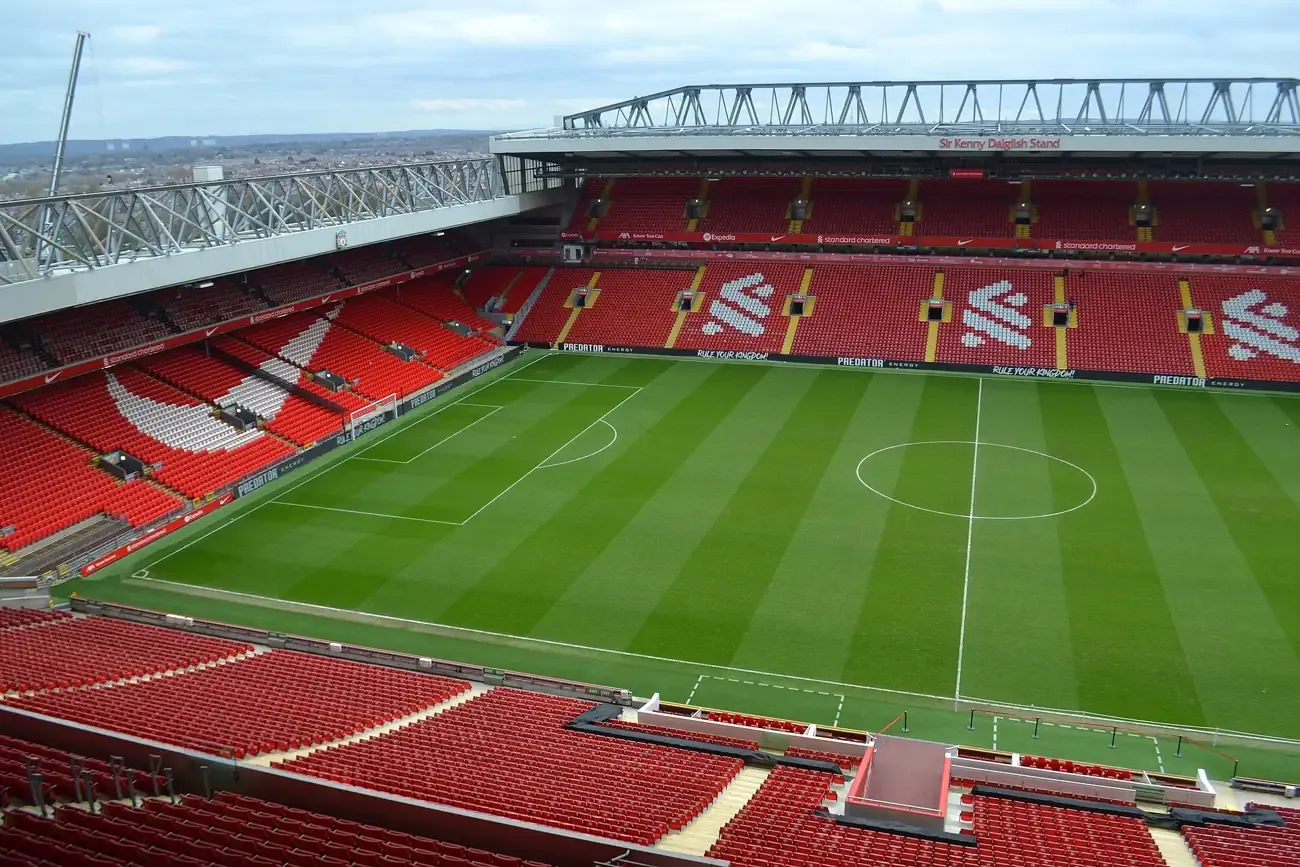 Inside Anfield, the red seats of the Kop stand and the pitch, Liverpool