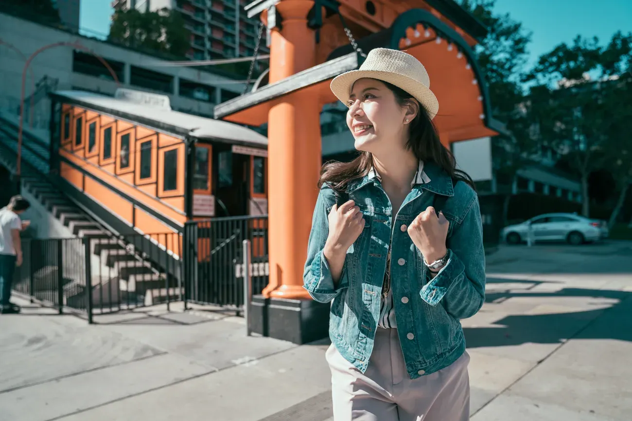 A traveller beside the orange Angels Flight funicular car in Los Angeles