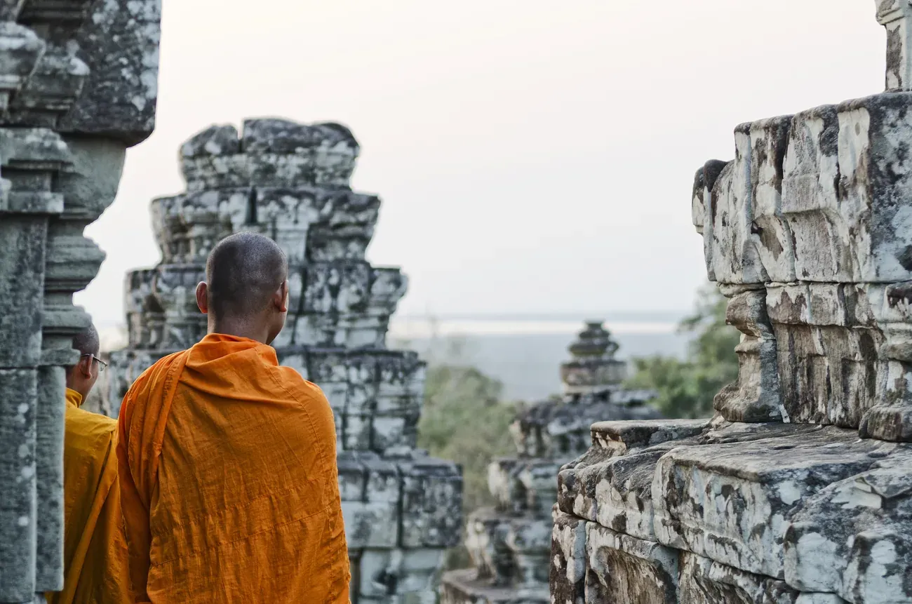 A Buddhist monk overlooking Angkor Wat near Siem Reap, Cambodia