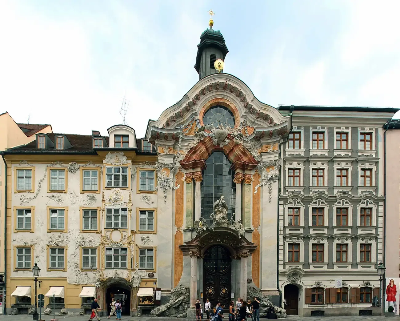 The ornate Baroque facade of the Asamkirche squeezed between houses on Sendlinger Strasse in Munich