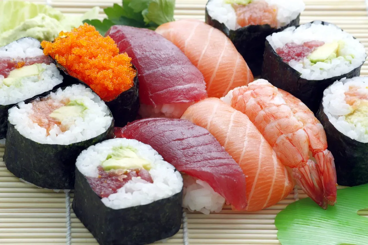 Assorted nigiri and maki sushi arranged on a bamboo mat
