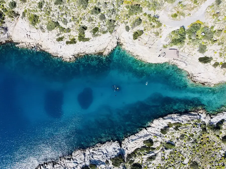 Swimmers in a rocky cove at Limanakia Vouliagmenis on the Athens Riviera