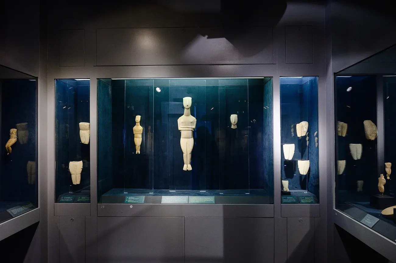 Slim Early Cycladic marble figurines in glass cases in a gallery of the Museum of Cycladic Art in Athens