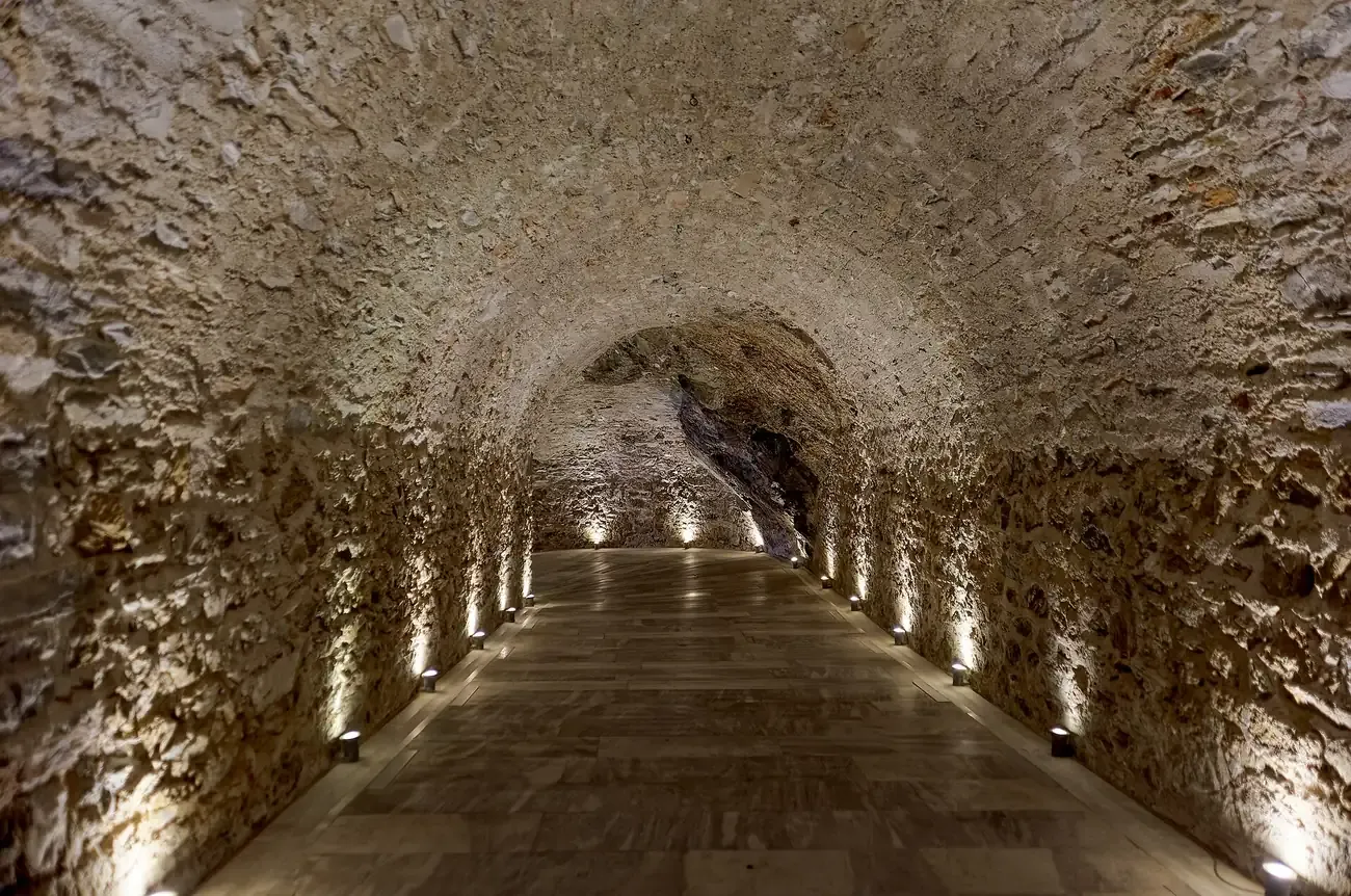 The long vaulted stone tunnel beneath the Panathenaic Stadium in Athens, lit along its walls
