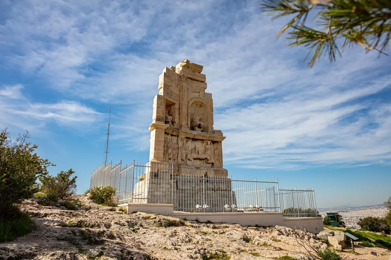 The ancient Philopappos Monument on Mouseion Hill against a blue sky, Athens