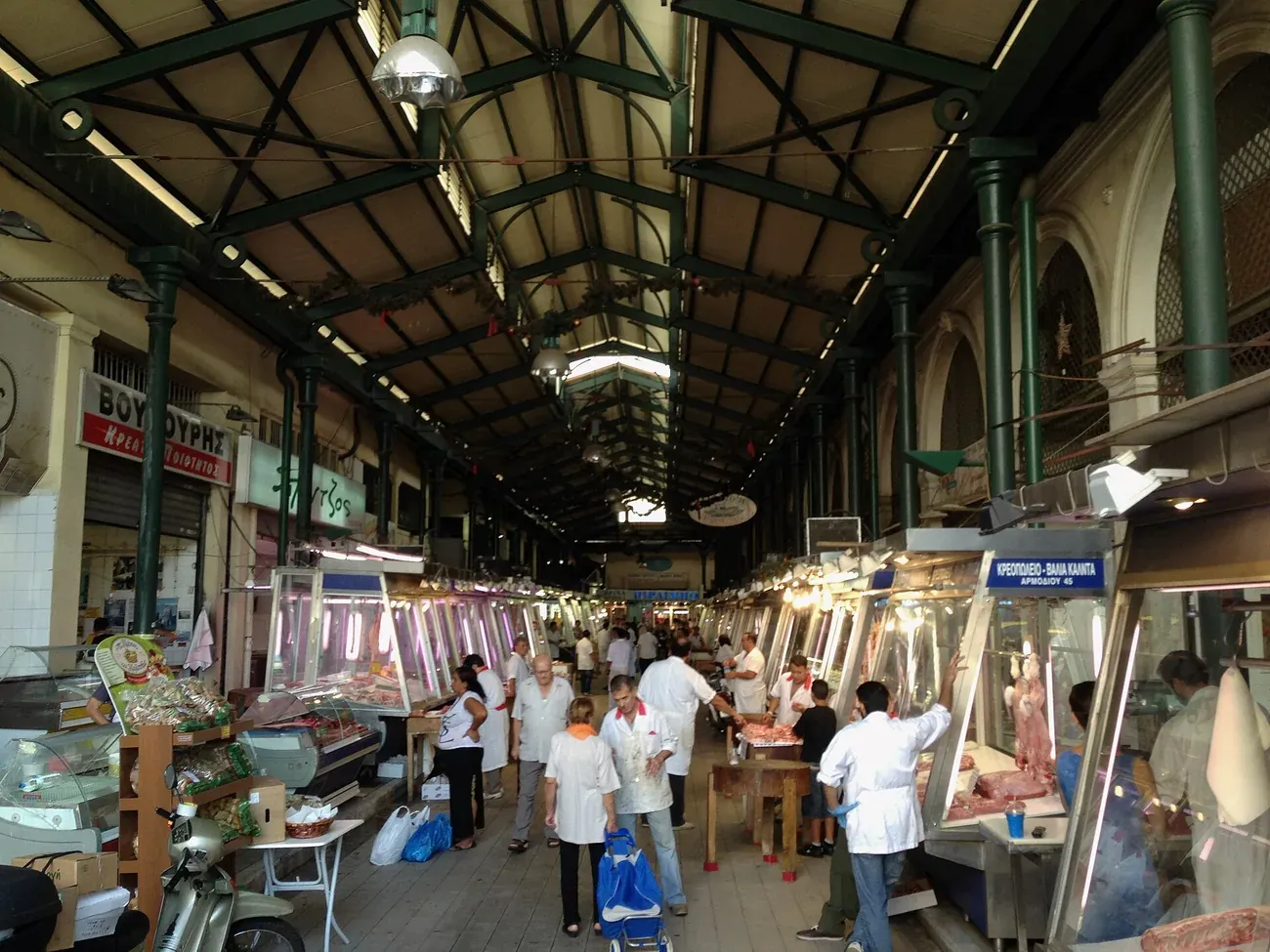 Butchers and shoppers along the covered iron-roofed hall of the Varvakios Central Market in Athens