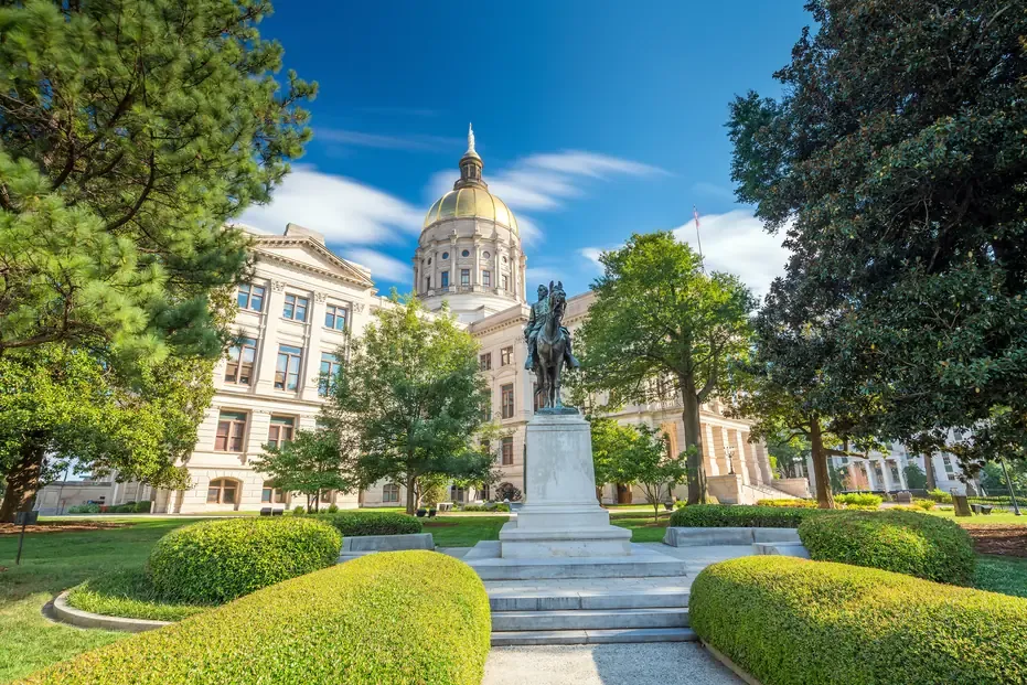 The gilded dome of the Georgia State Capitol above its lawn in Atlanta