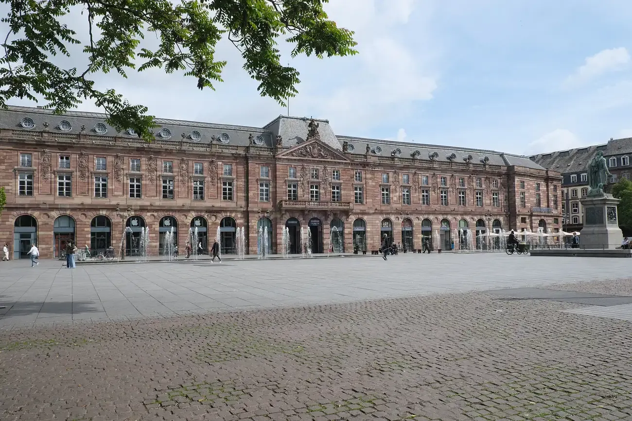 The Aubette building on place Kléber in Strasbourg seen across the square under a leafy branch