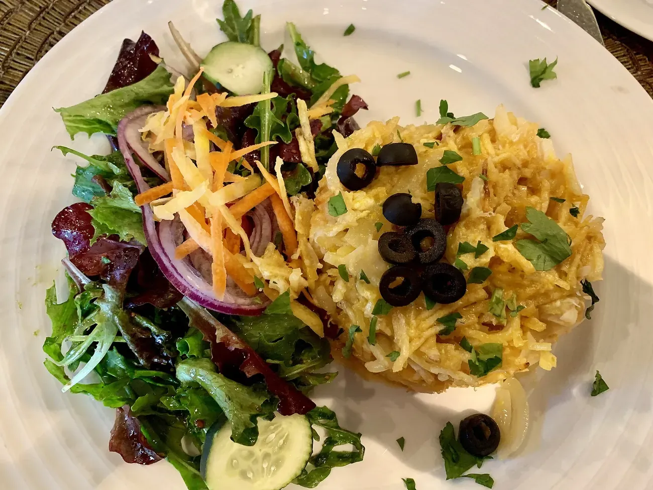 A plate of bacalhau a Bras, salt cod with eggs and straw potatoes