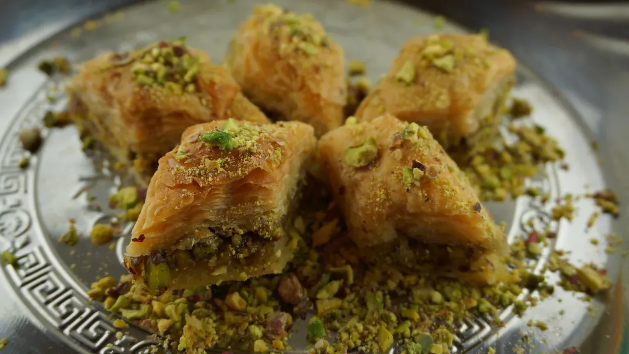 Pistachio baklava arranged on a metal tray