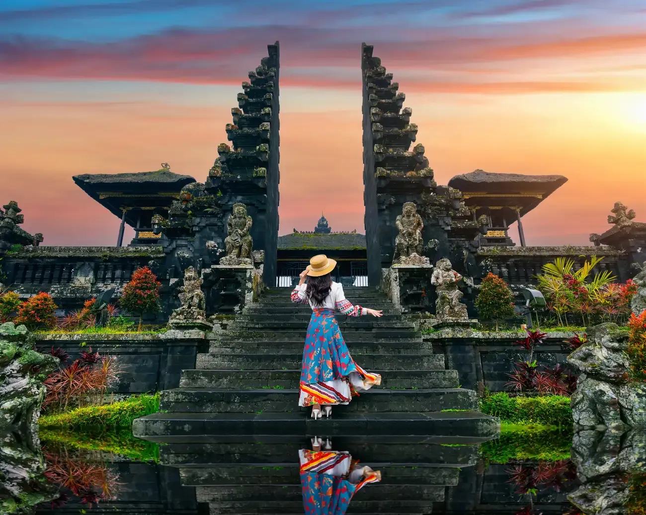 Visitors in sarongs standing at the gates of Besakih Temple in Bali
