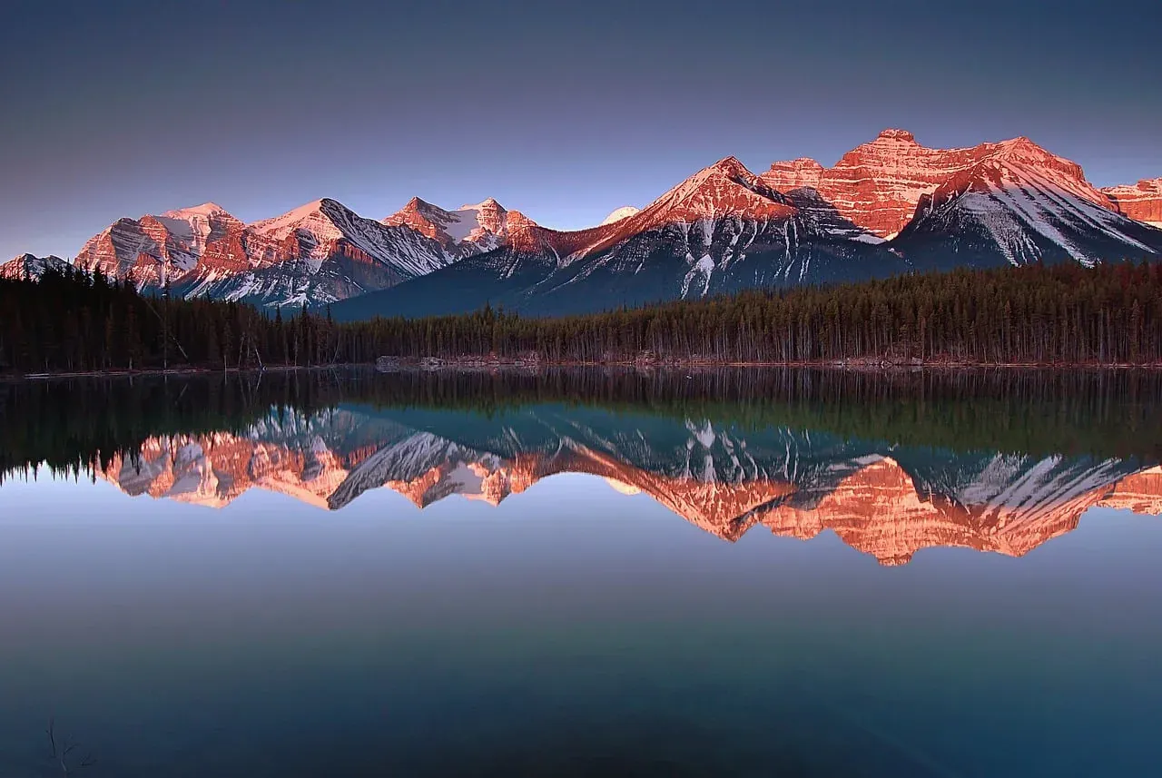 Peaks reflected in Herbert Lake at first light in Banff National Park