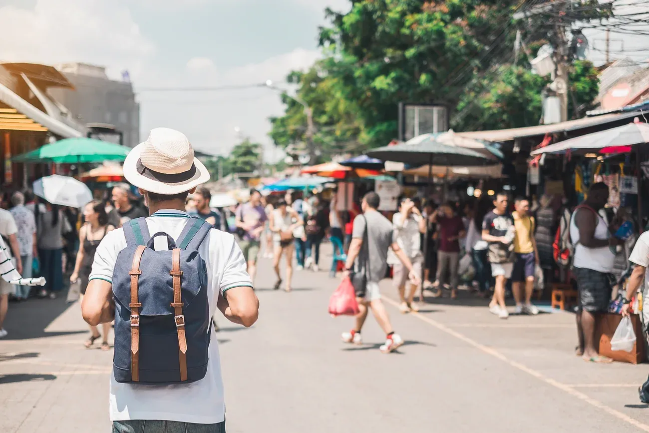 Visitors walking between the stalls of Chatuchak Weekend Market in Bangkok