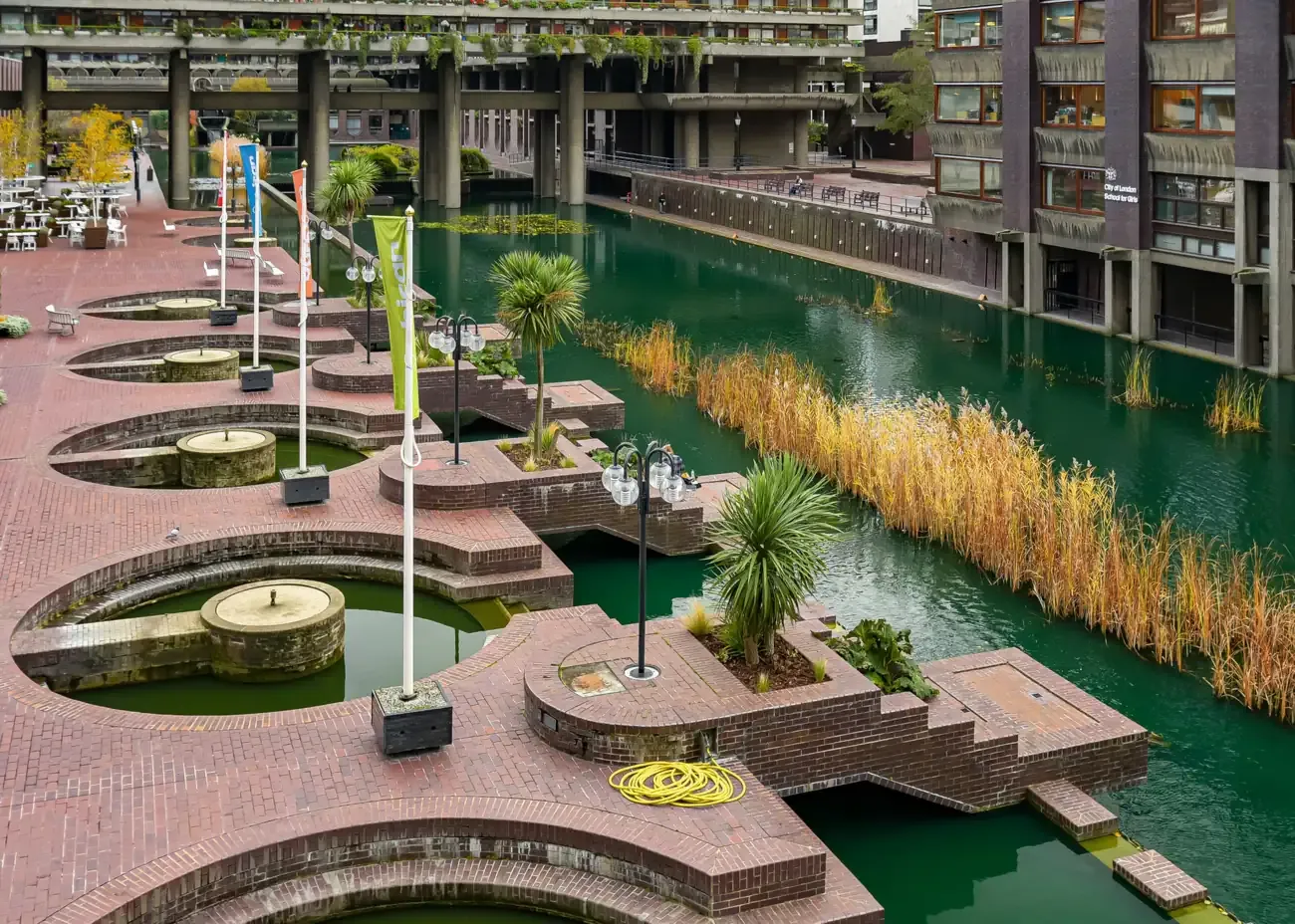 The lakeside terrace, fountains and brutalist towers of the Barbican Centre in the City of London