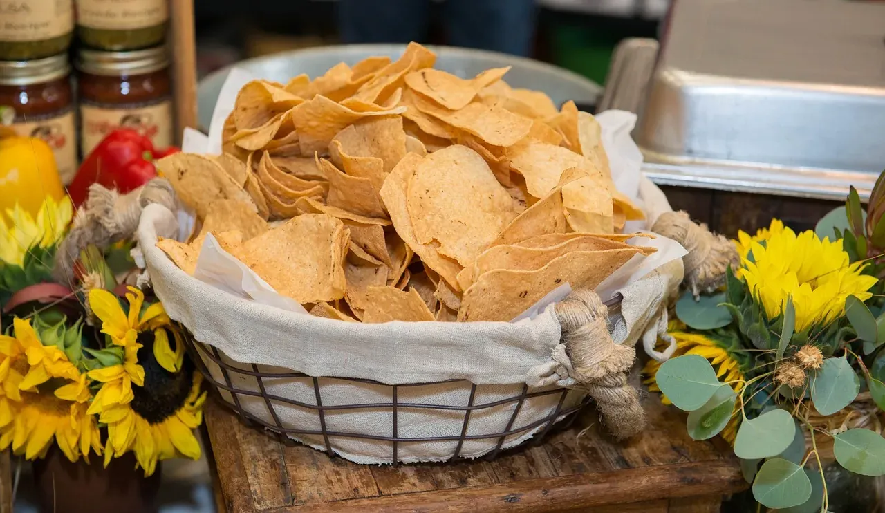 A basket of tortilla chips served with salsa in a Tex-Mex restaurant