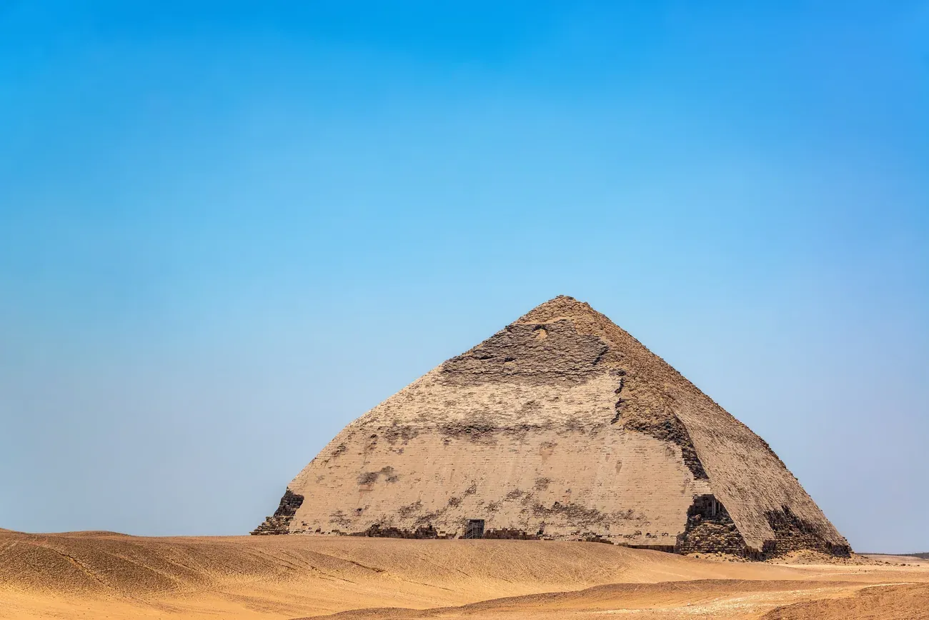 The Bent Pyramid of Sneferu with its distinctive change of slope in the desert at Dahshur, south of Cairo.