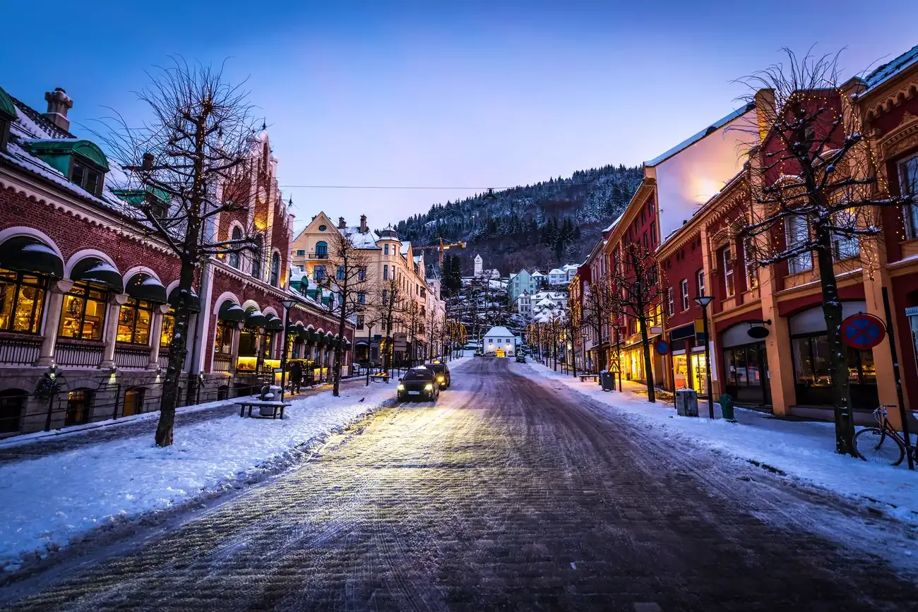 A snow-covered street in Bergen, Norway, decorated for Christmas