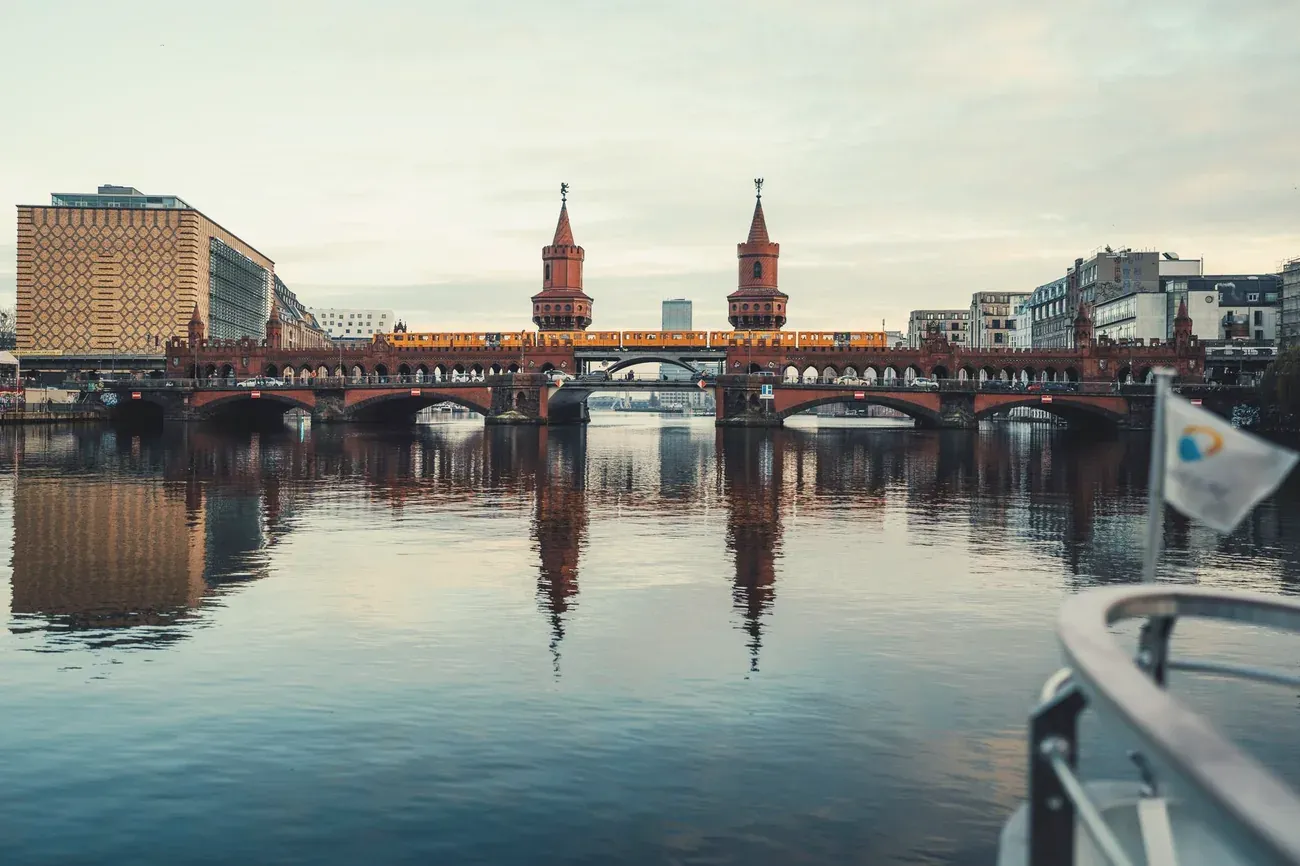 Oberbaum Bridge over the Spree with a train crossing at dusk