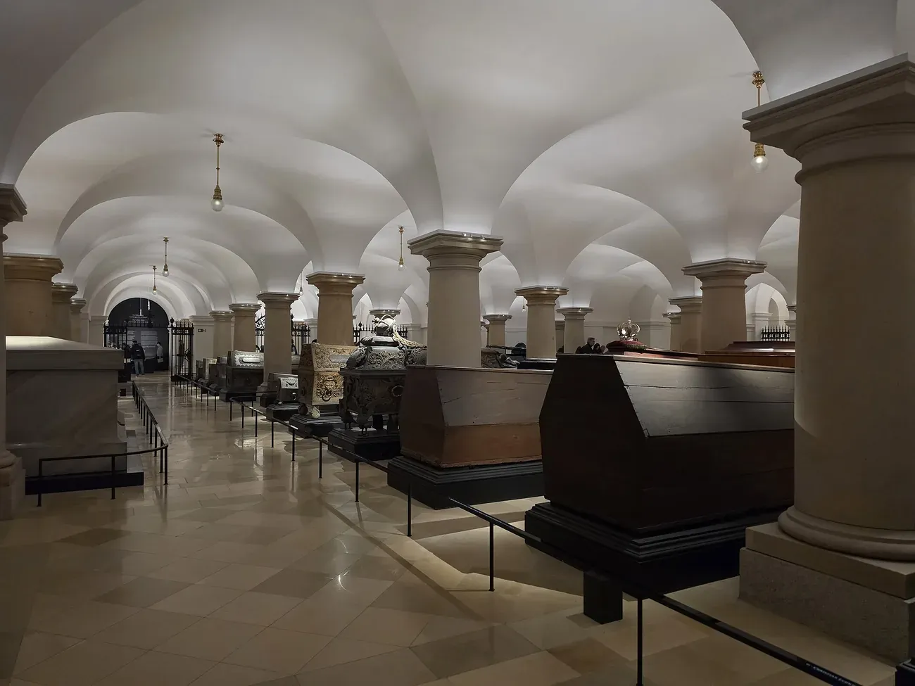 Rows of Hohenzollern sarcophagi under the vaulted ceiling of the crypt beneath Berlin Cathedral