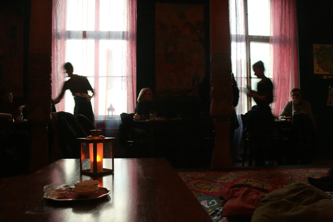 The carved and painted interior of the Tajikistan Tearoom in Berlin, with low tables and cushions on the floor
