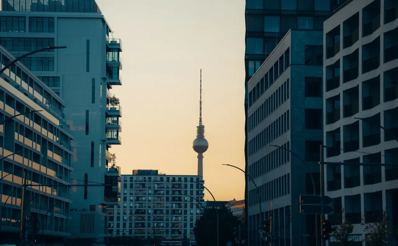 Berlin TV Tower between buildings at sunrise