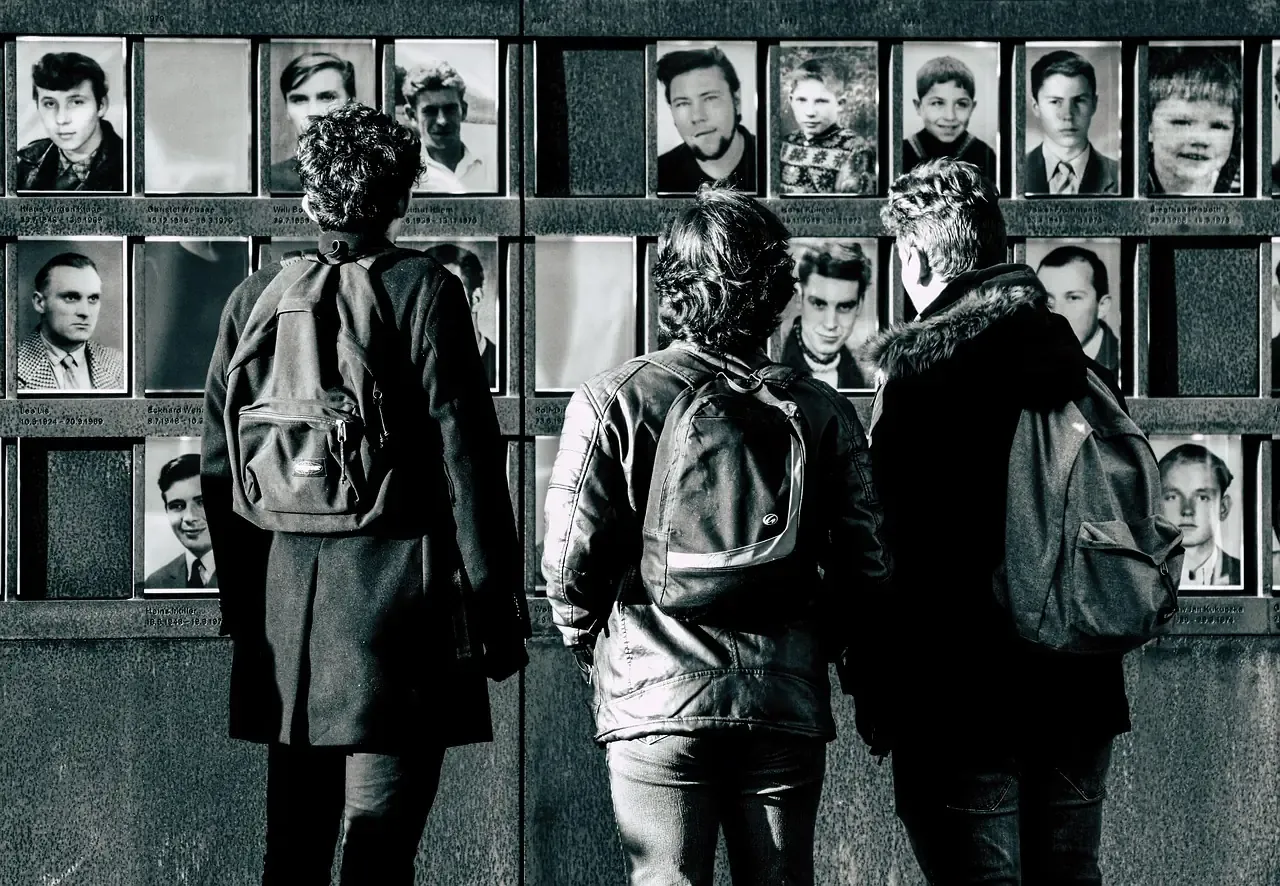 Visitors at the wall of portraits in the Berlin Wall Memorial on Bernauer Strasse