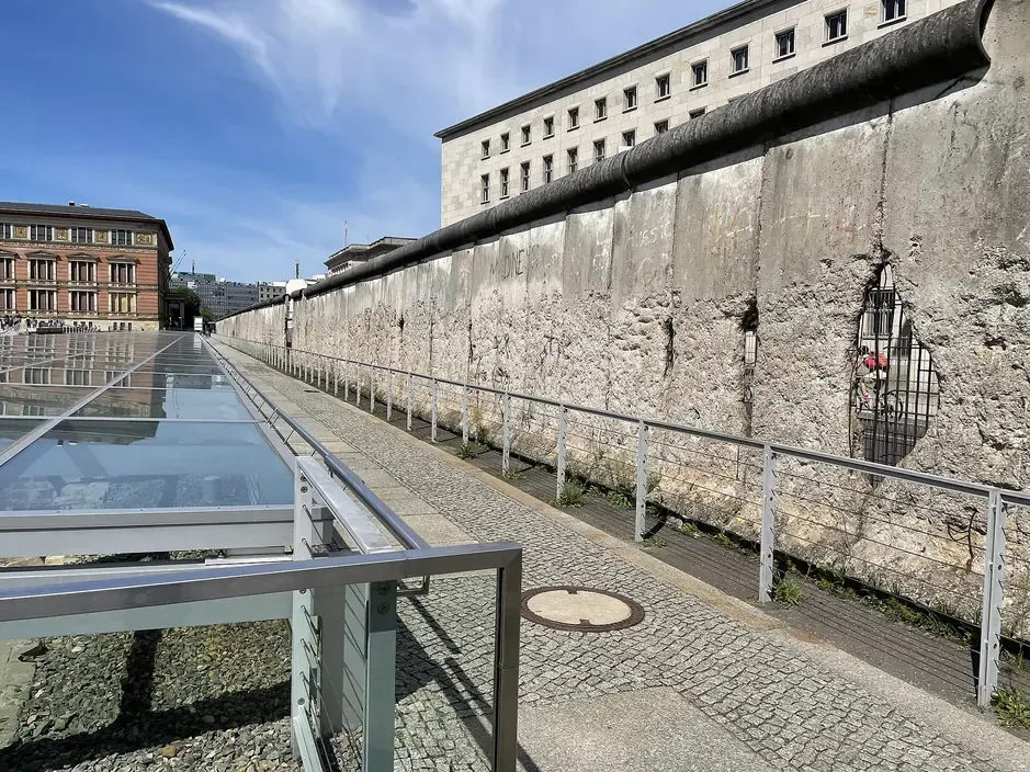 A surviving segment of the Berlin Wall along Niederkirchnerstrasse in Mitte, with the former Reich Aviation Ministry building behind it