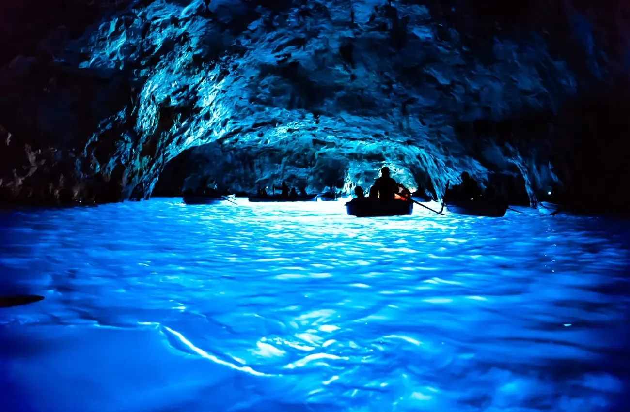 Rowboats inside the Blue Grotto sea cave, Capri