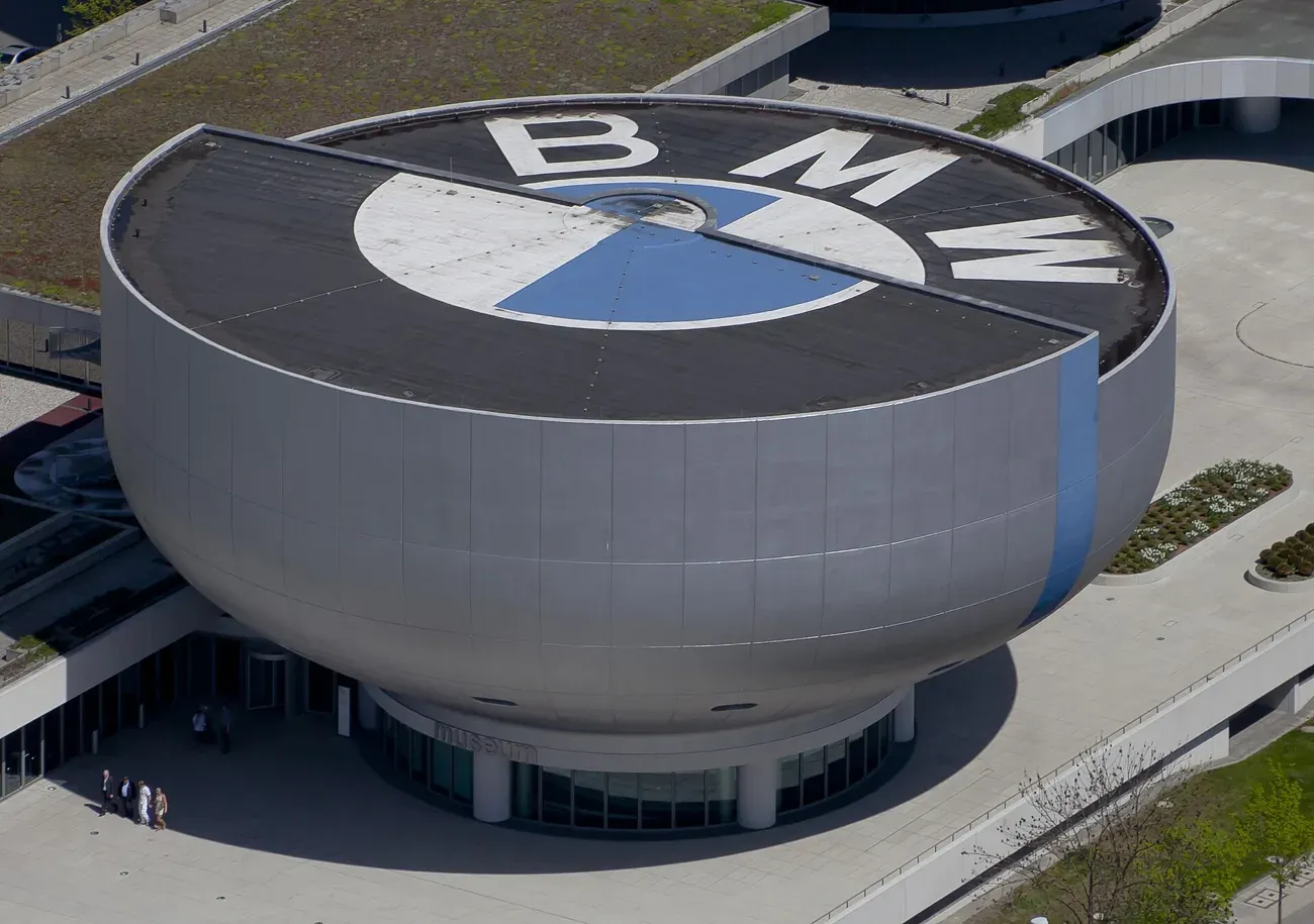 The silver bowl-shaped BMW Museum building topped by the BMW roundel in Munich