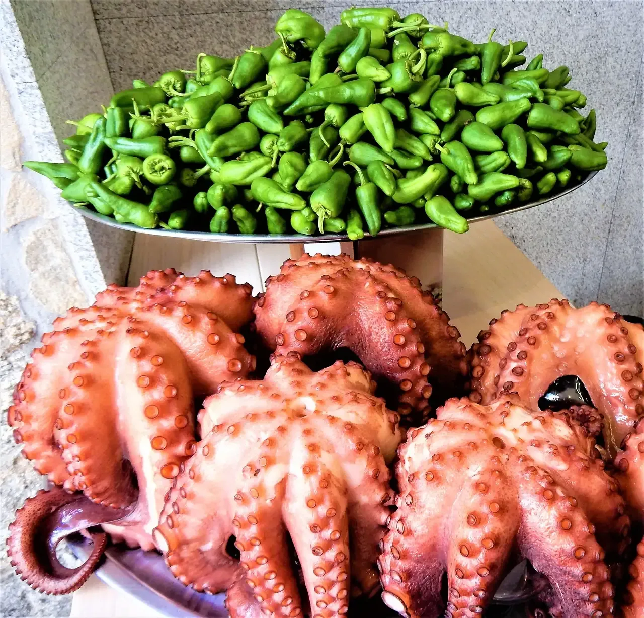 Boiled octopus and padron peppers on a Spanish food stall