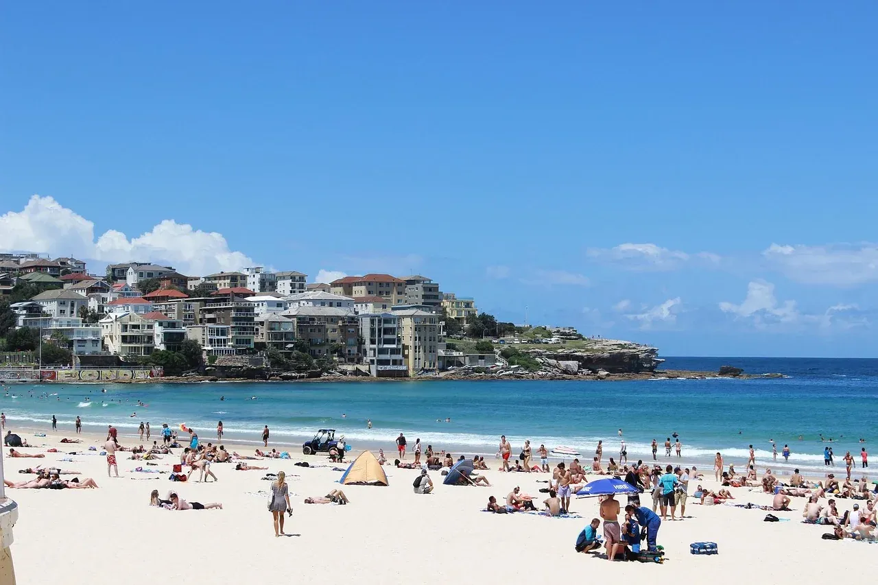 Swimmers and sunbathers on the sand at Bondi Beach on a summer day in Sydney
