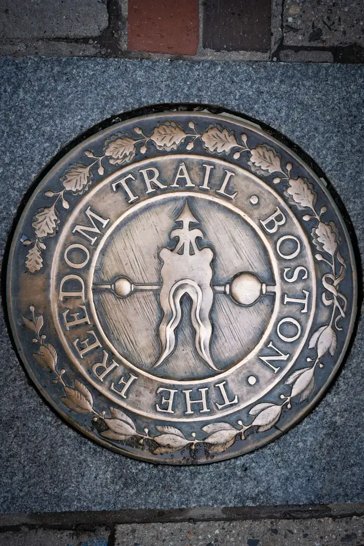 A marker for the Freedom Trail set into a sidewalk in Boston