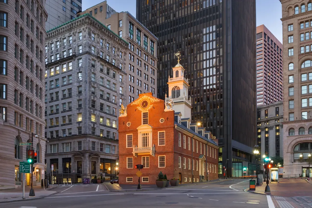 The red-brick Old State House surrounded by downtown towers at dawn in Boston