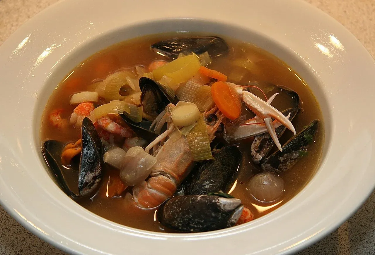 A bowl of bouillabaisse with mussels, shellfish and fish in saffron broth