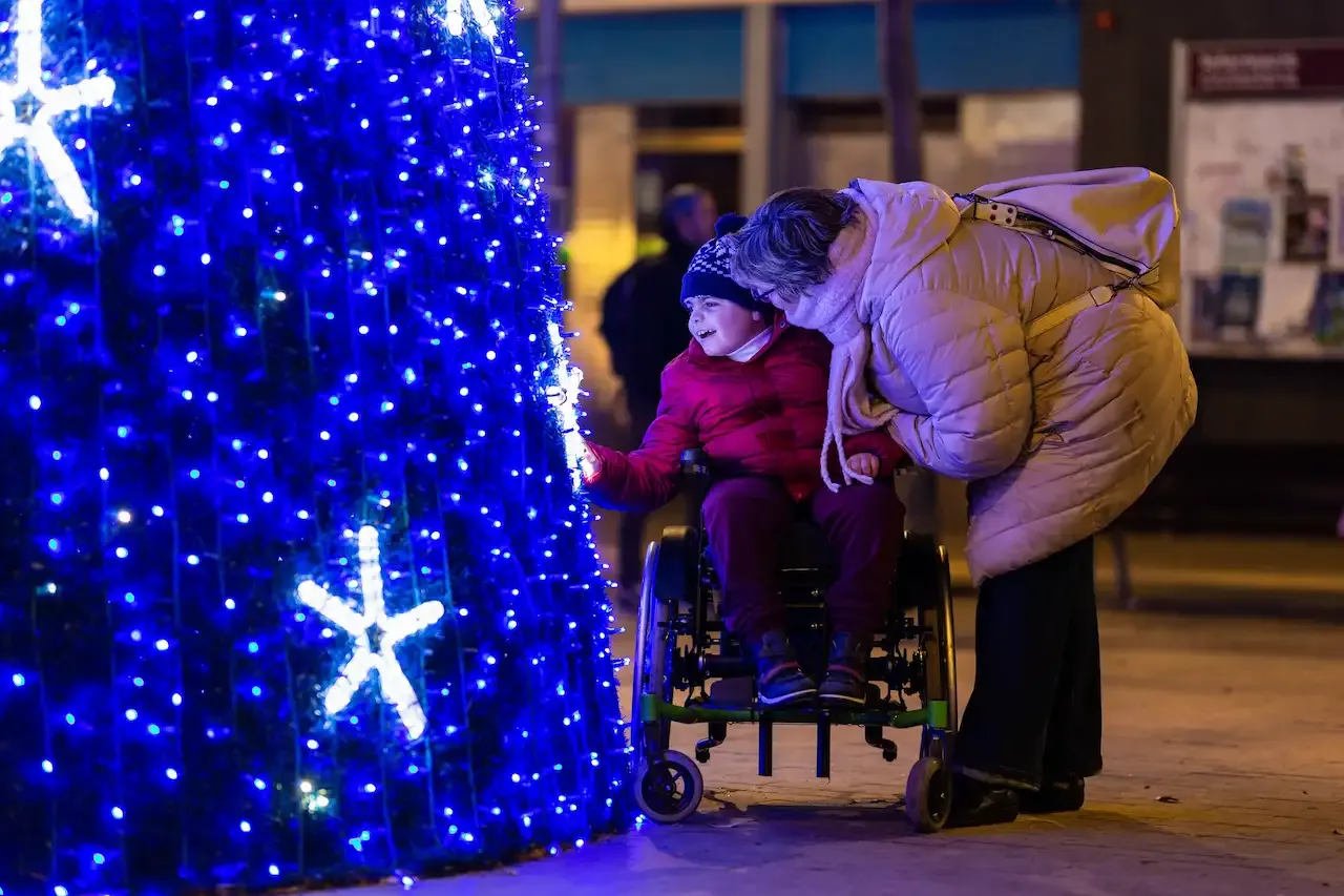 A boy in a wheelchair at a Christmas market
