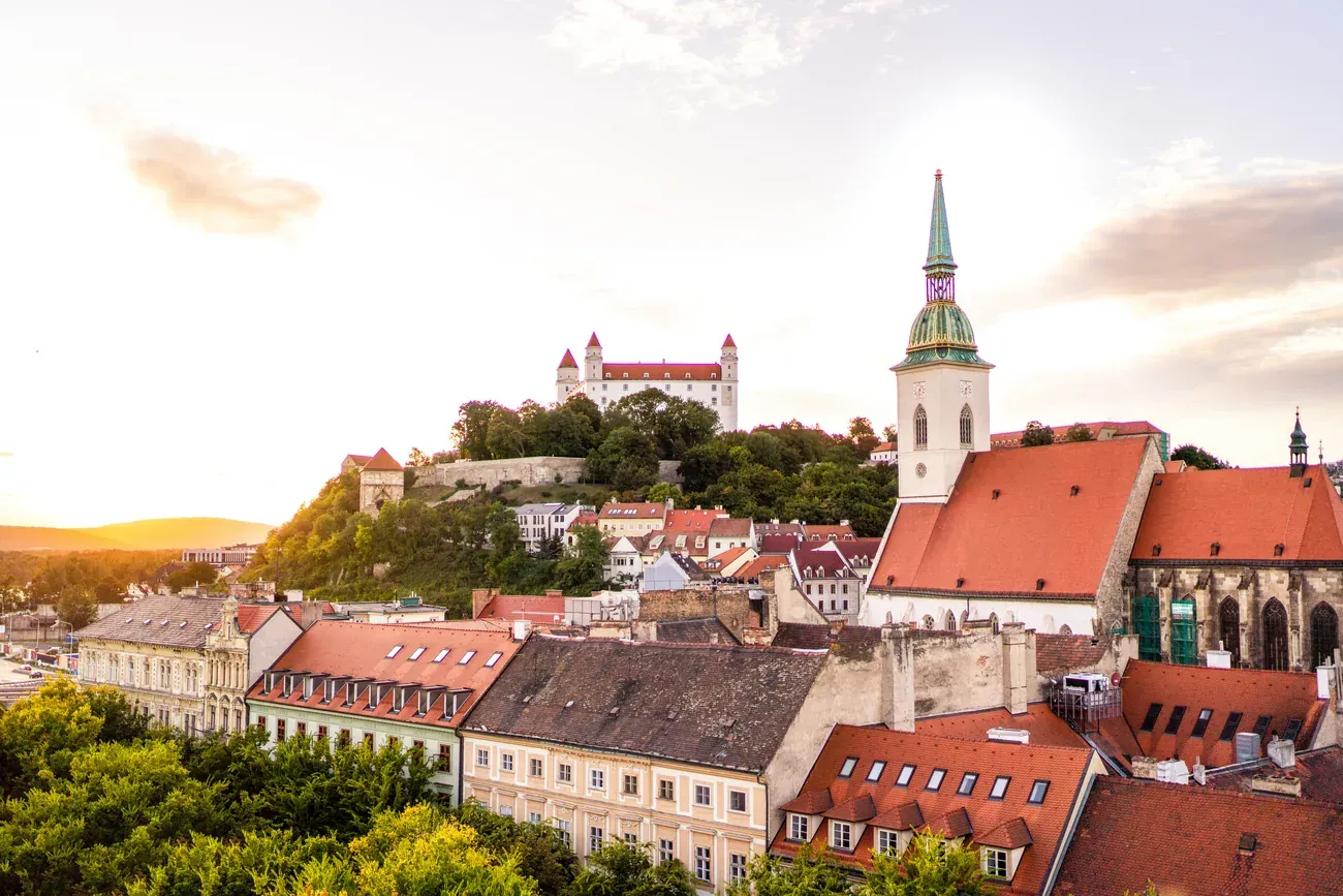 Bratislava Castle and the old town skyline, with St. Martin's Cathedral spire, at sunset