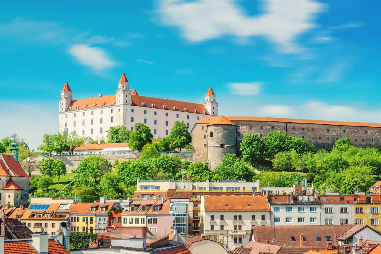 Bratislava Castle on its hilltop above the old town's red rooftops, seen from Michael's watchtower
