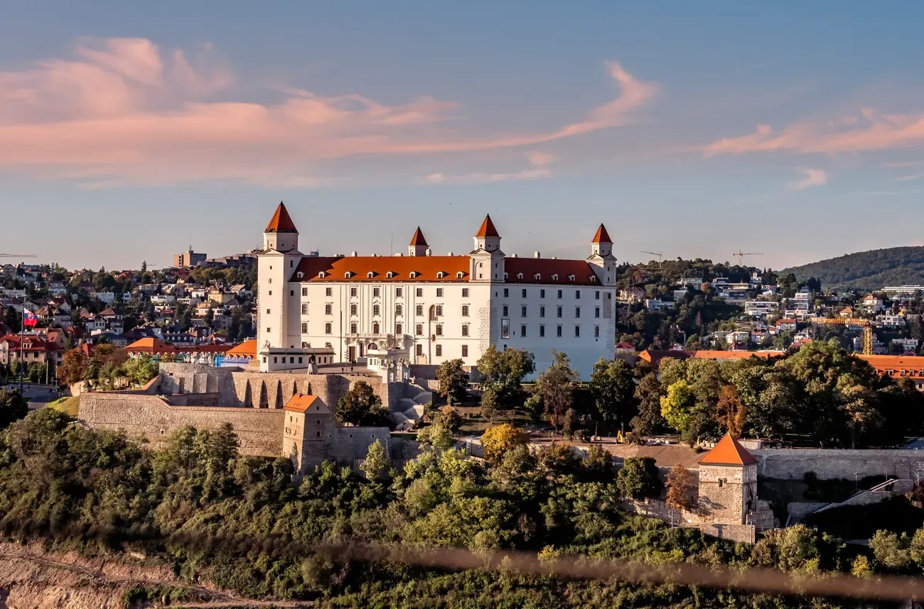 Bratislava Castle overlooking the city at sunset, a popular day trip from Vienna