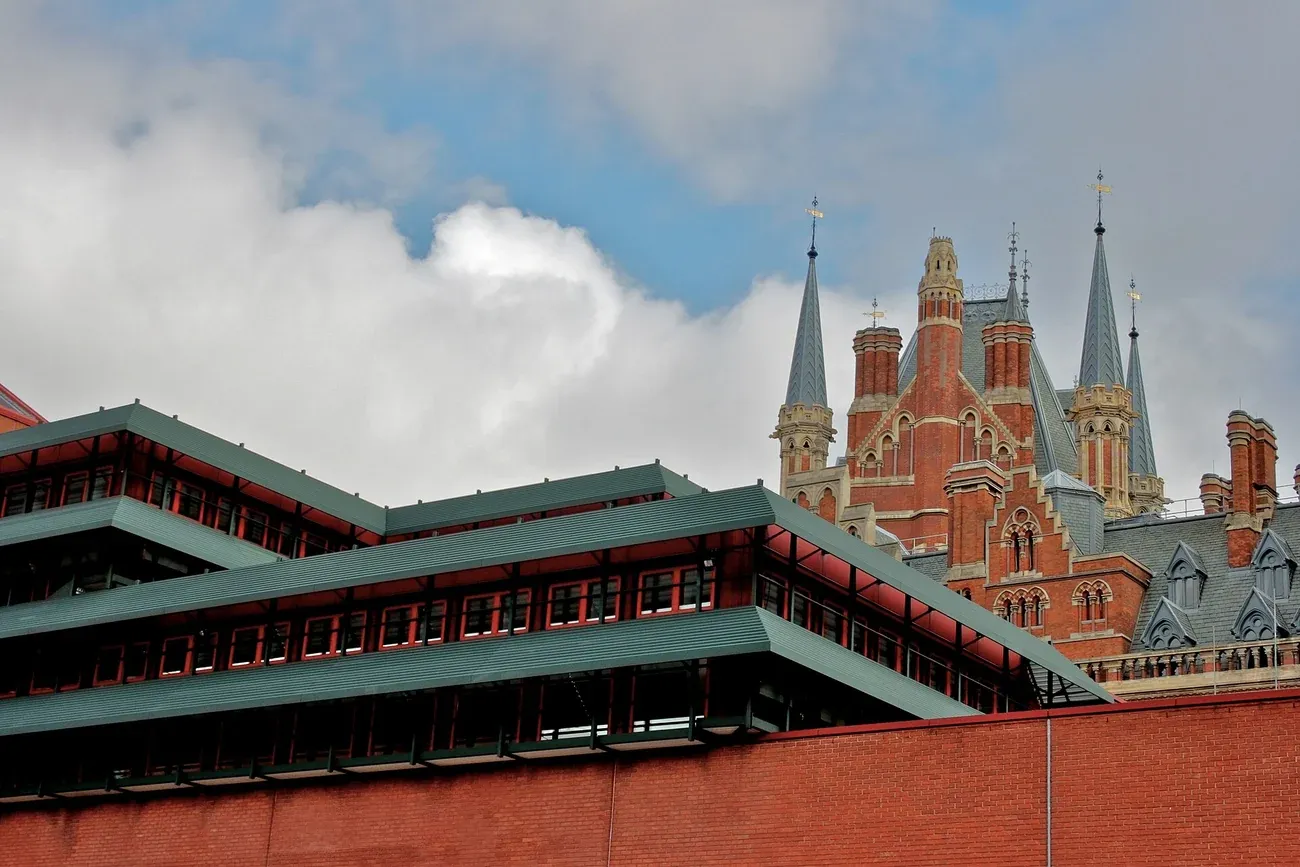 The red-brick British Library with the Gothic towers of St Pancras station behind, London