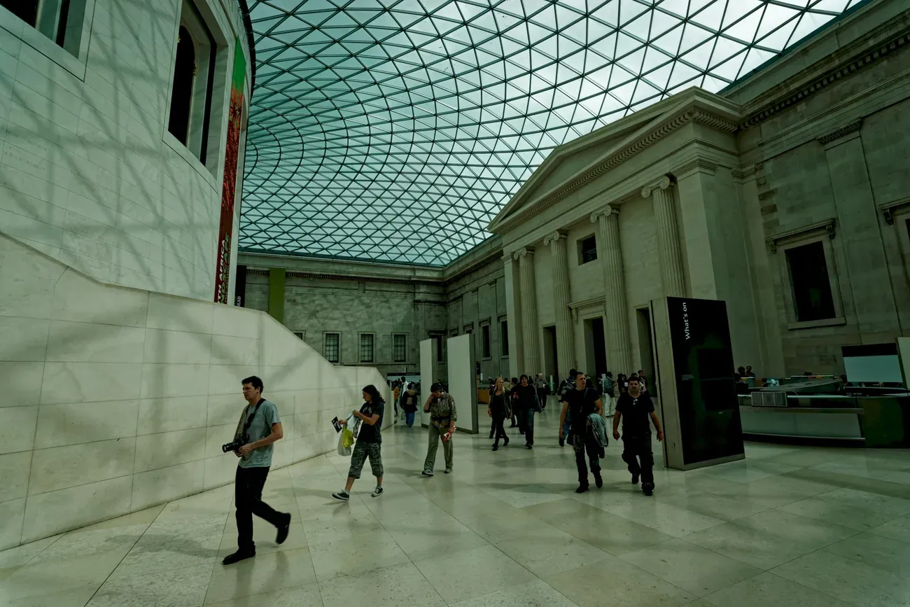 Visitors crossing the glass-roofed Great Court of the British Museum in London