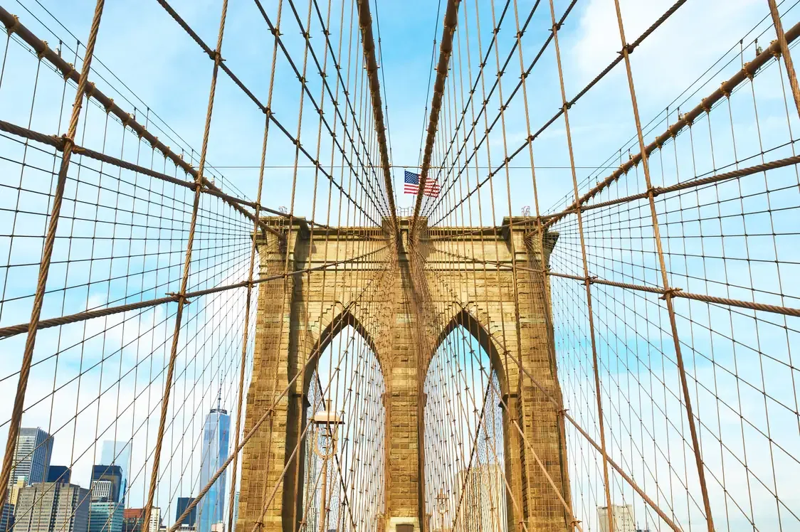 The Brooklyn Bridge tower and cables with the Manhattan skyline behind