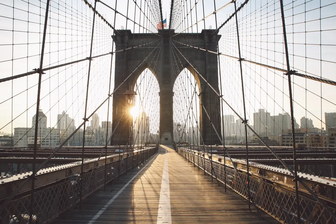 The Brooklyn Bridge pedestrian walkway at sunrise in New York City