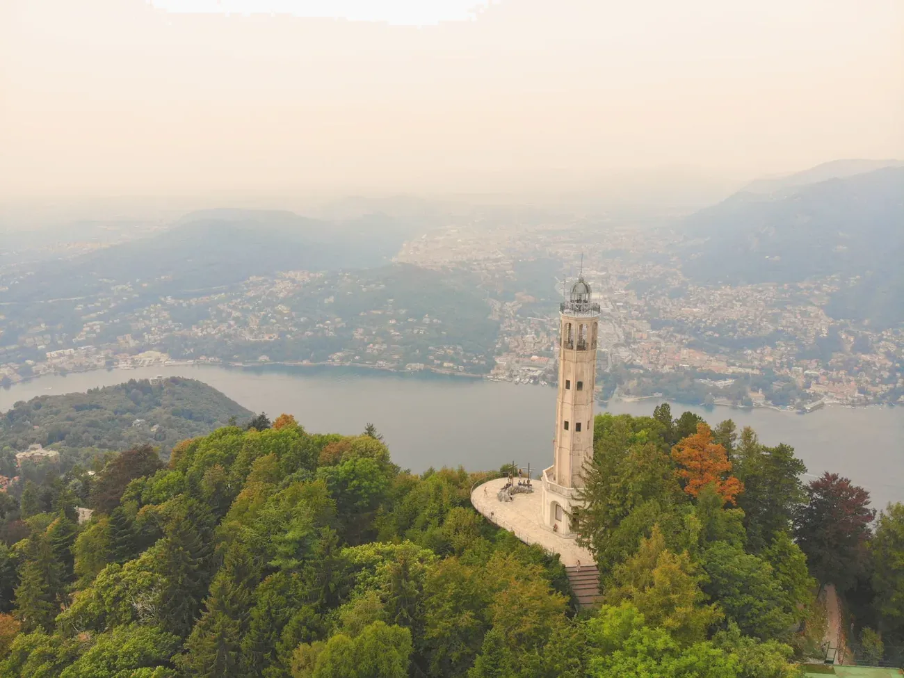 Aerial view of the Faro Voltiano lighthouse in Brunate on the wooded ridge above Lake Como