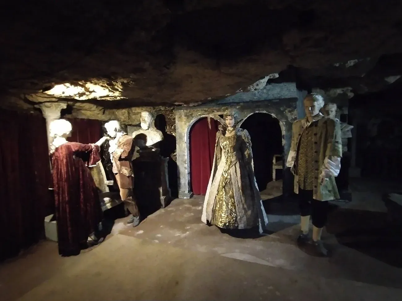 Waxwork figures in period costume staged inside the rock-cut caves beneath Castle Hill in Budapest