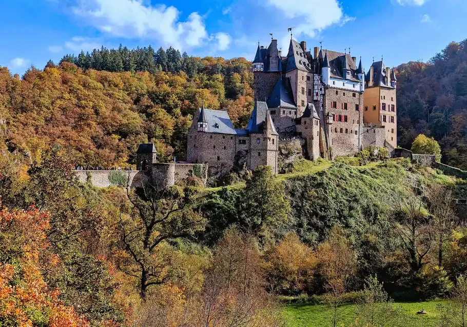 Eltz Castle seen from the west above the autumn woods of the Elzbach valley