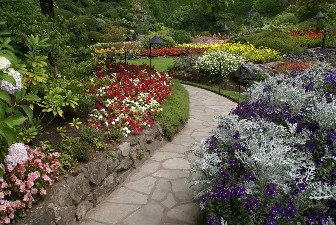 Flower borders along a stone path at The Butchart Gardens